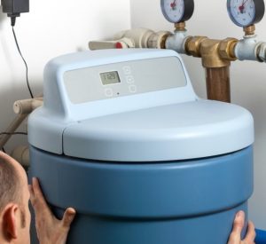 Technician from Ace Pelizon installing a water softener in Covina, Ca